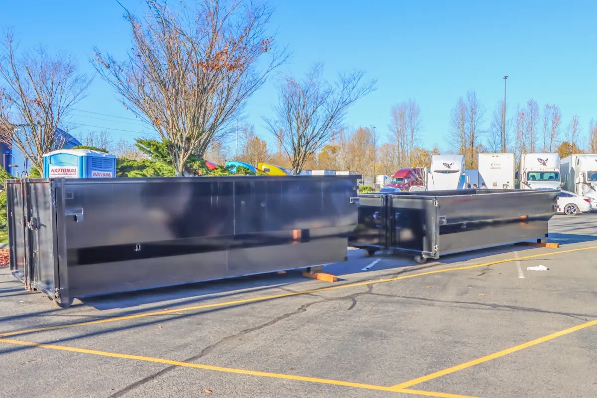 Professional dumpster rental service with roll-off container on residential driveway in Morro Bay
